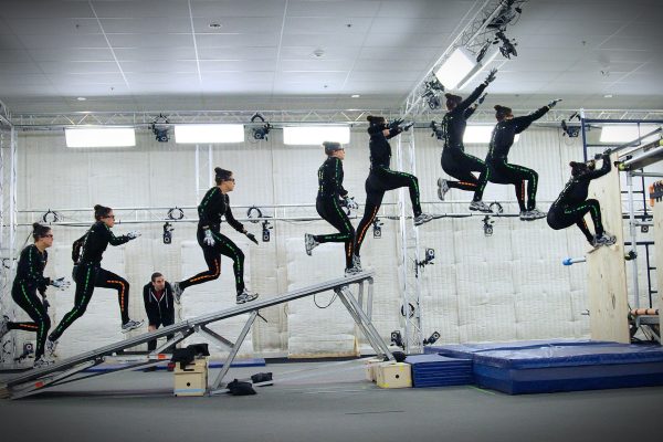 time lapse image of motion capture stunt woman run up ramp and jump on stage in the performance capture studio