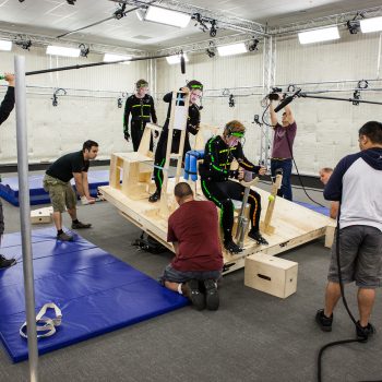 motion captures studio on large rig surrounded by sound and video crew in performance capture studio